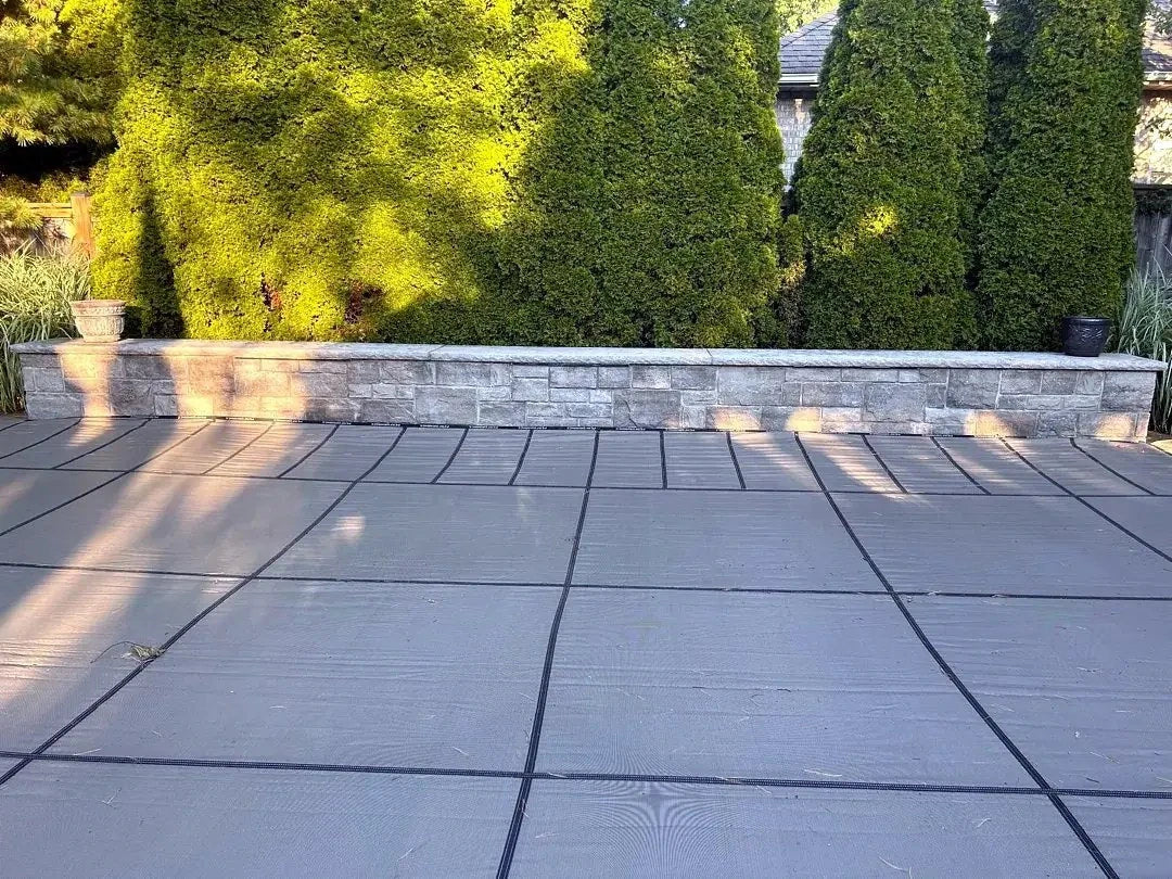Details at the boundary. A fitted cover meets a raised stone edge.