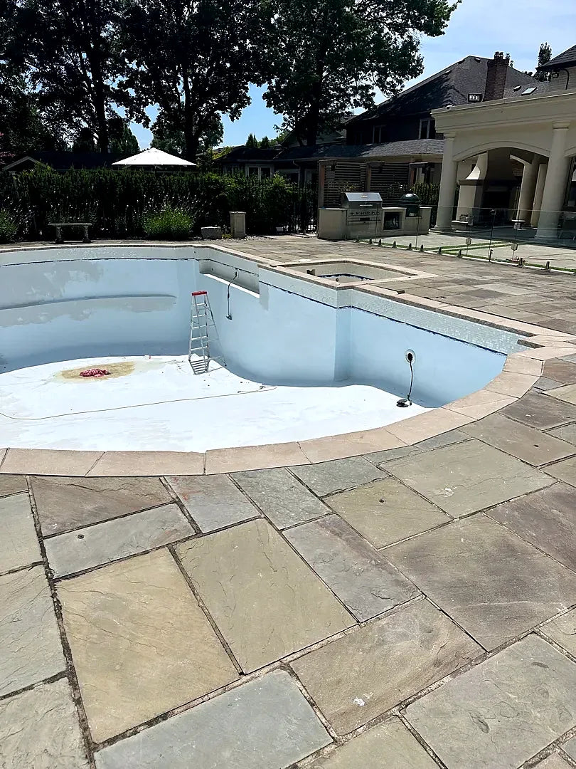 The same pool drained, before the waterline tile is replaced